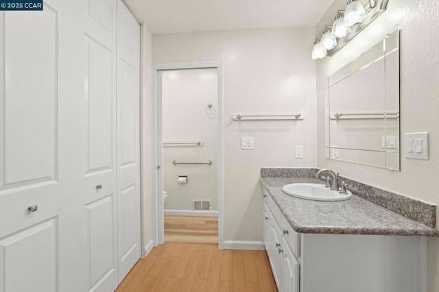 bathroom featuring vanity and hardwood / wood-style floors