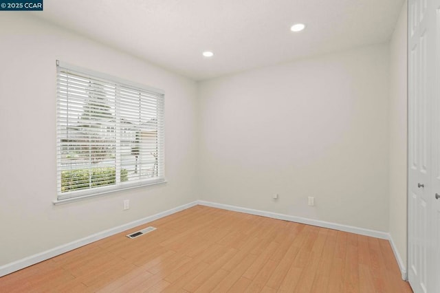 spare room with hardwood / wood-style floors