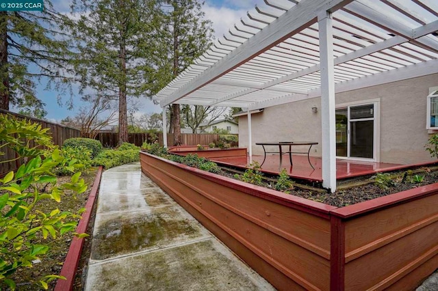 view of patio / terrace featuring a wooden deck and a pergola