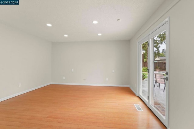 spare room with light wood-type flooring