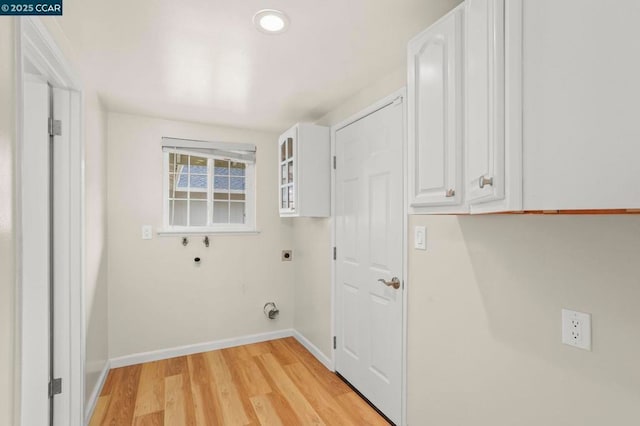 washroom featuring hookup for a washing machine, light wood-type flooring, cabinets, and hookup for an electric dryer