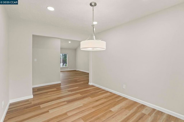 unfurnished dining area featuring light wood-type flooring