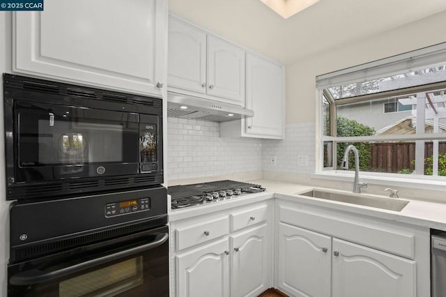 kitchen featuring tasteful backsplash, sink, stainless steel appliances, and white cabinets