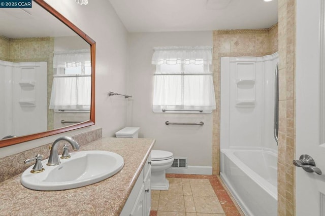 full bathroom with vanity, bathtub / shower combination, tile patterned floors, and toilet