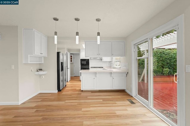 kitchen with white cabinetry, stainless steel fridge with ice dispenser, and decorative light fixtures