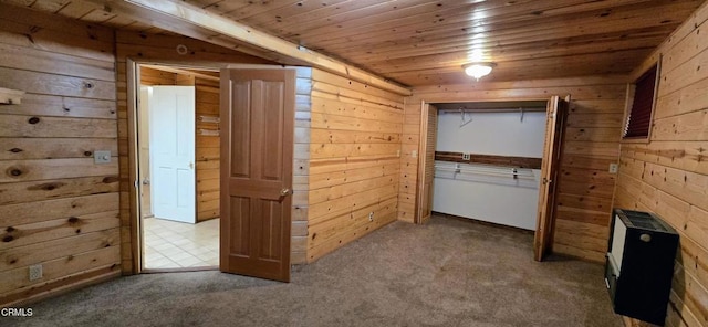 interior space with wooden walls, carpet, and wooden ceiling