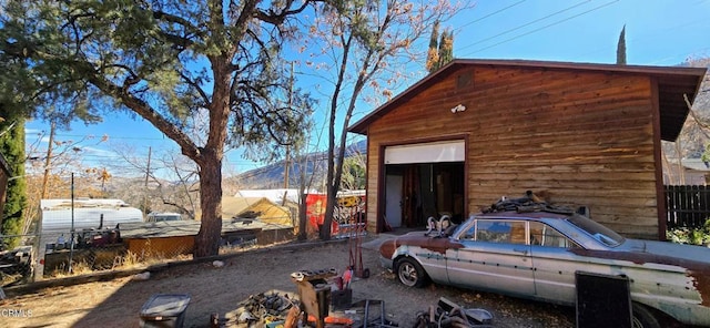 view of side of home with an outbuilding and a garage