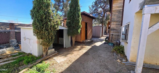 view of side of home with a storage unit