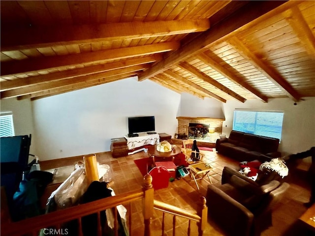 additional living space featuring a stone fireplace, lofted ceiling with beams, and wooden ceiling