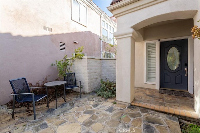 entrance to property featuring a patio