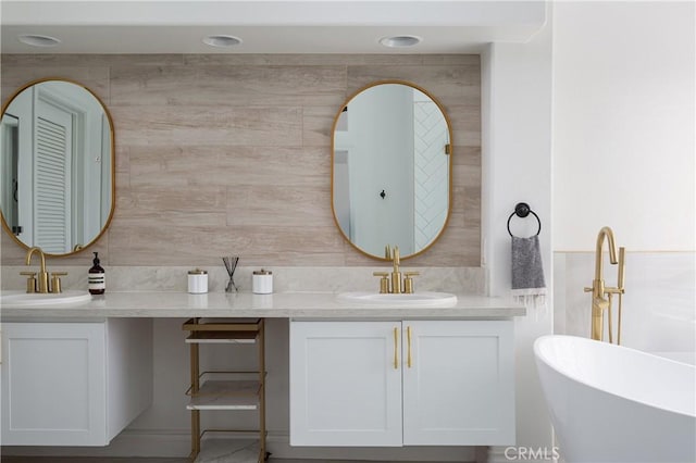 bathroom featuring vanity, a bath, backsplash, and tile walls