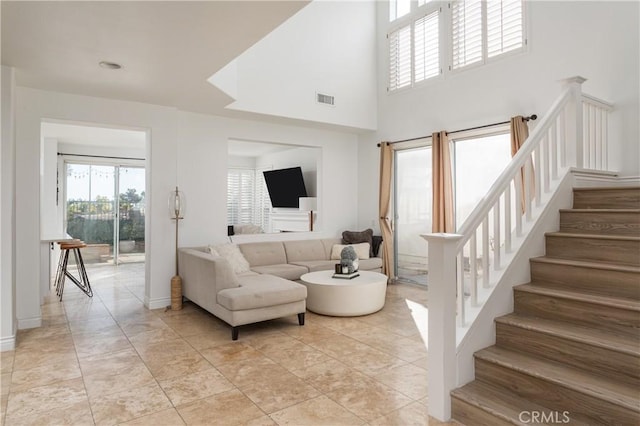 living room featuring a towering ceiling