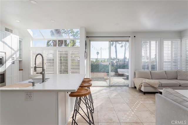 living room with sink and light tile patterned floors