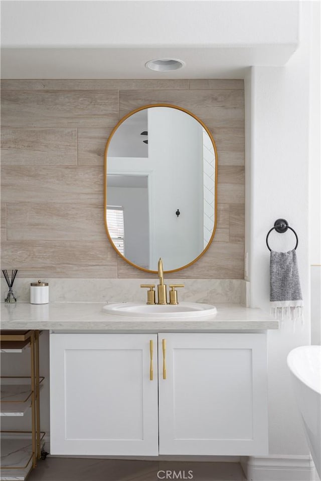 bathroom with vanity and decorative backsplash