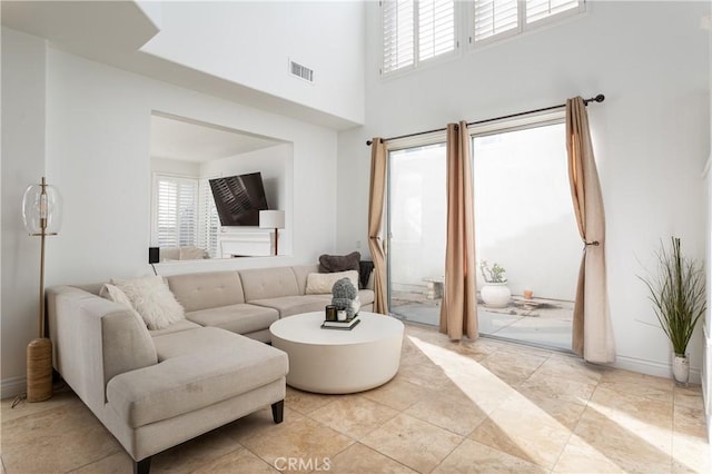 living room with a healthy amount of sunlight and a high ceiling