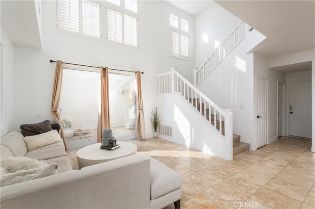 living room featuring a towering ceiling