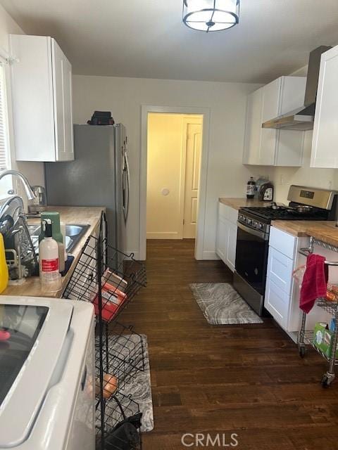 kitchen featuring appliances with stainless steel finishes, dark hardwood / wood-style floors, white cabinetry, sink, and butcher block counters