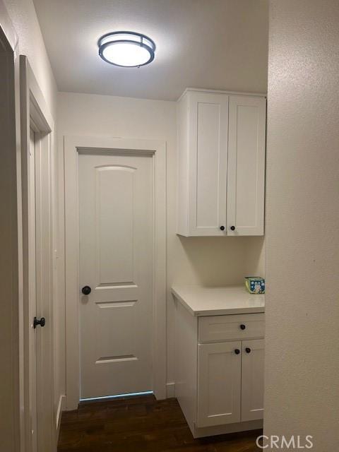 doorway with dark hardwood / wood-style flooring