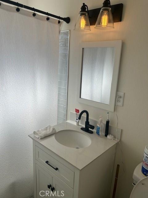 bathroom with vanity and toilet