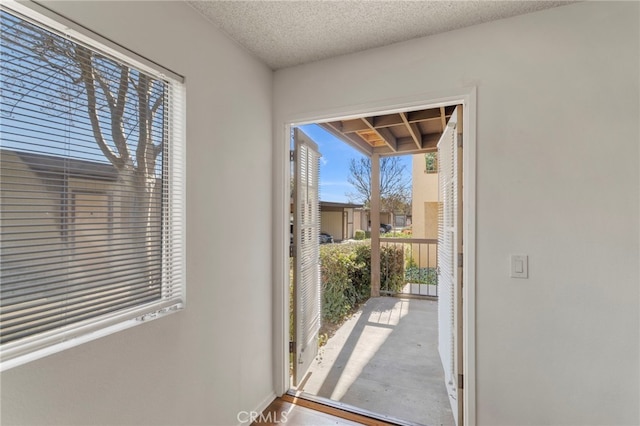 entryway featuring a textured ceiling