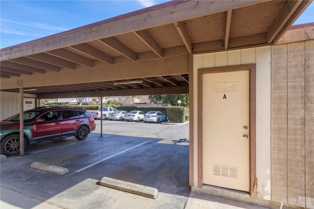 view of parking / parking lot featuring a carport