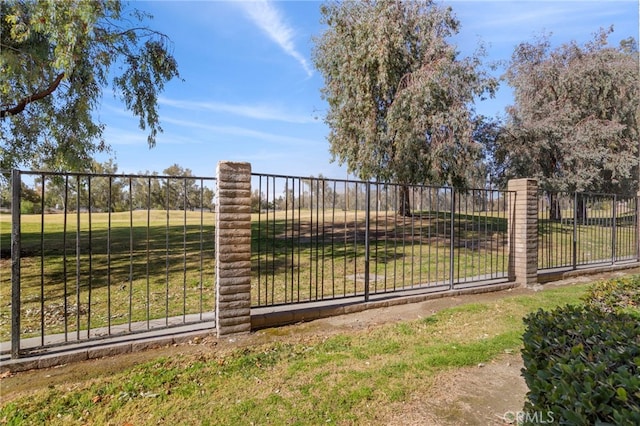 view of gate featuring a yard