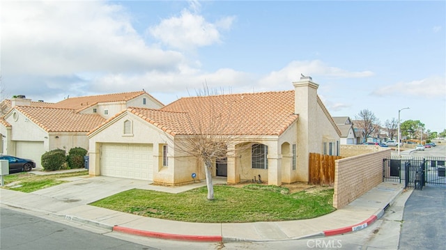 mediterranean / spanish-style home with a garage