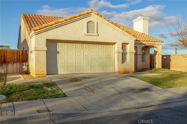 mediterranean / spanish home with a garage