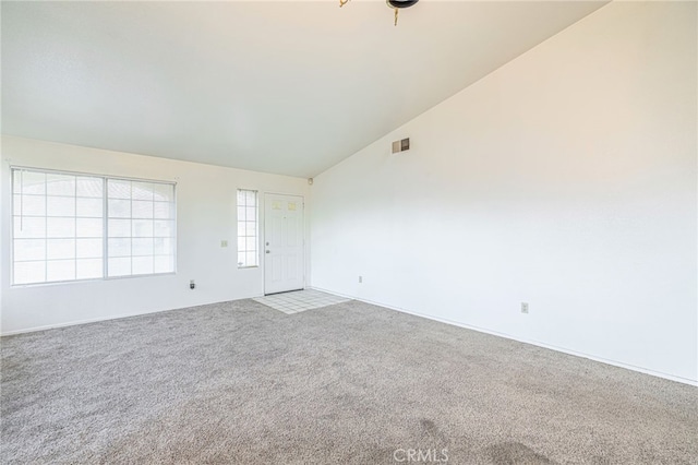 interior space featuring carpet and high vaulted ceiling