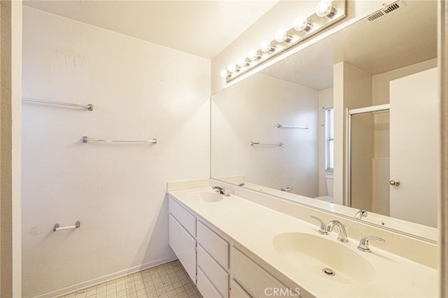 bathroom featuring a shower with door, vanity, and toilet