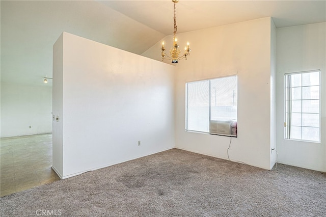 unfurnished room with an inviting chandelier, lofted ceiling, and light carpet