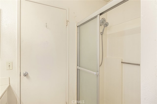 bathroom with a shower with shower door