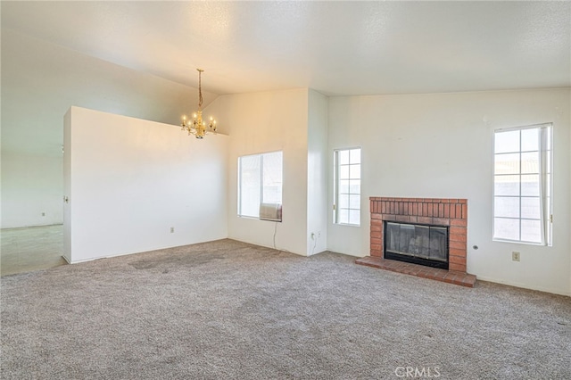 unfurnished living room with lofted ceiling, carpet floors, a fireplace, a textured ceiling, and a chandelier