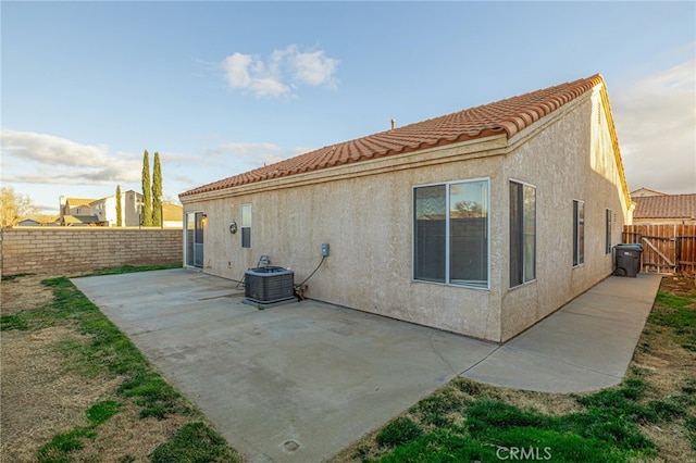 back of house with a patio area and central air condition unit