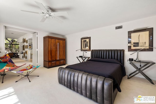 bedroom featuring light carpet and ceiling fan