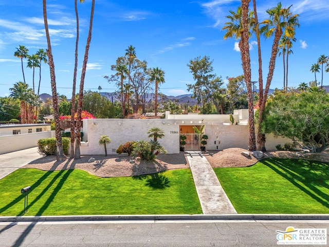 view of front facade with a mountain view and a front yard