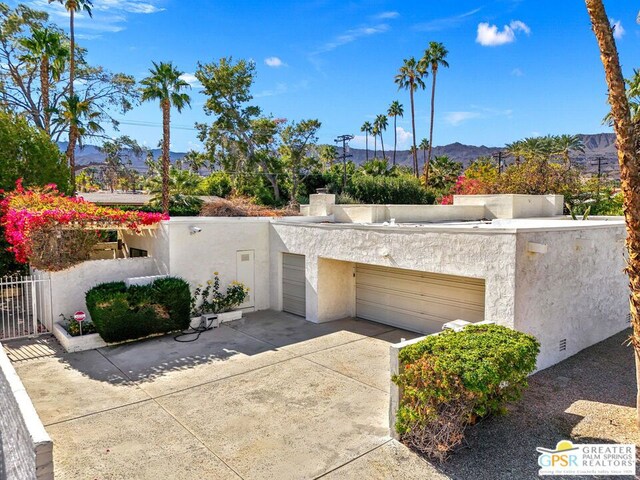 view of front of home featuring a garage and a mountain view