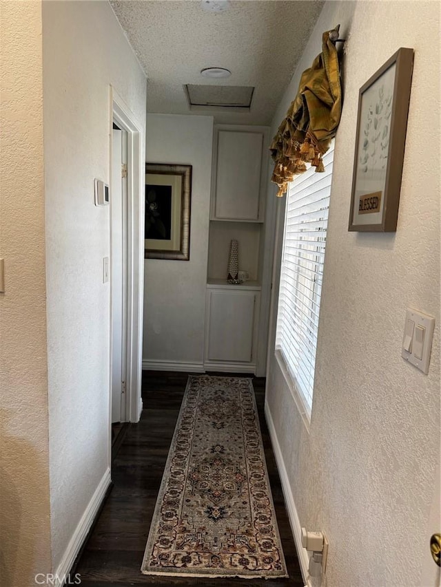 3319 Kellie Ave, Rosamond, CA 93560 - hallway featuring a textured ceiling, dark wood-style floors, baseboards, and a textured wall