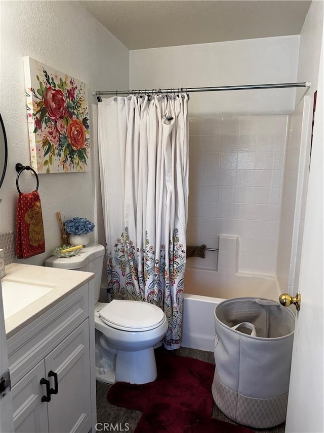 full bathroom featuring shower / bath combination with curtain, vanity, and toilet