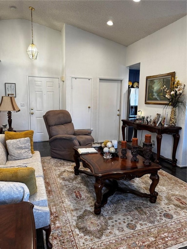 3319 Kellie Ave, Rosamond, CA 93560 - living room featuring lofted ceiling, wood finished floors, a textured ceiling, and recessed lighting