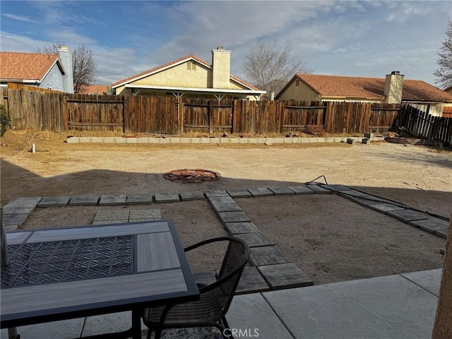 view of yard featuring a patio area and an outdoor fire pit