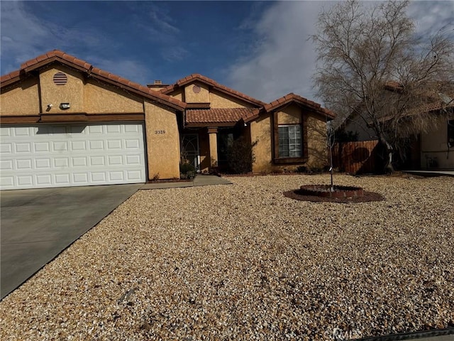 3319 Kellie Ave, Rosamond, CA 93560 - view of front of house with concrete driveway, stucco siding, a garage, and a tile roof