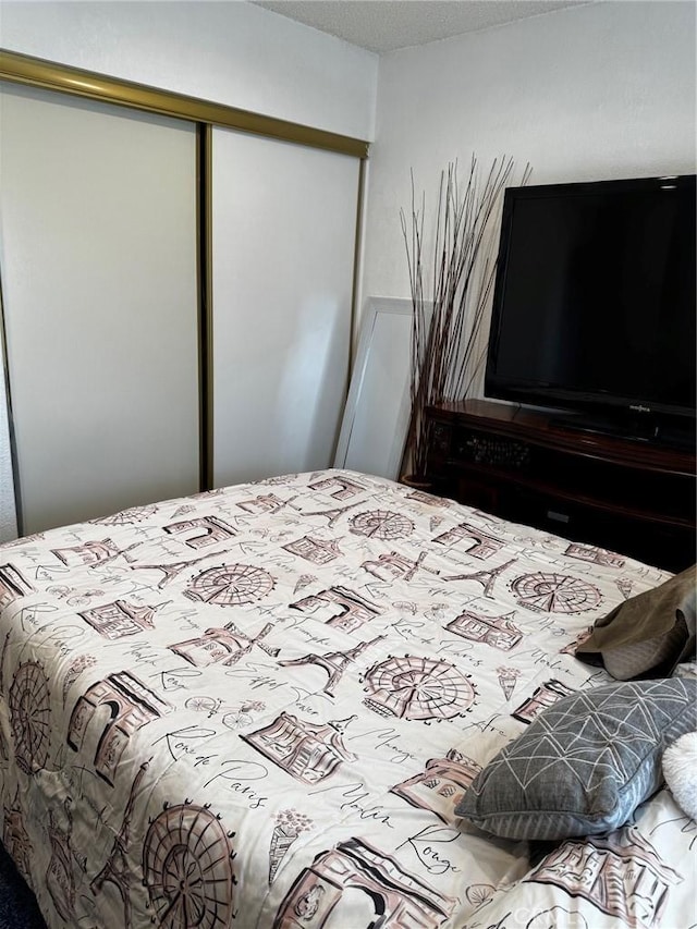 bedroom with a closet and a textured ceiling