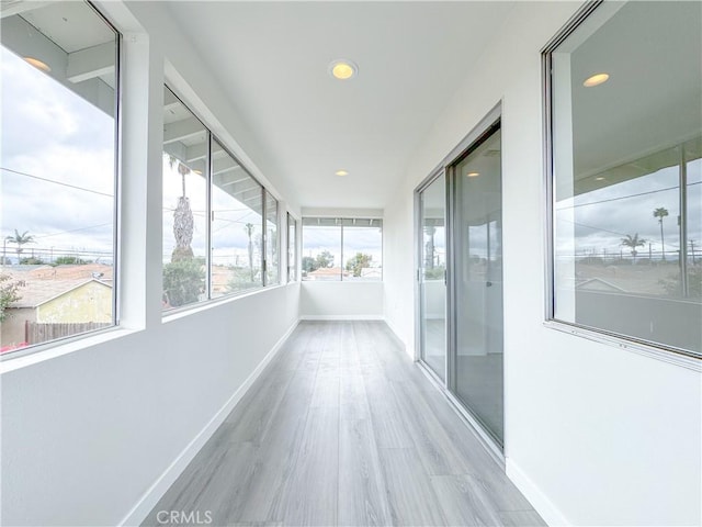 corridor with light hardwood / wood-style flooring