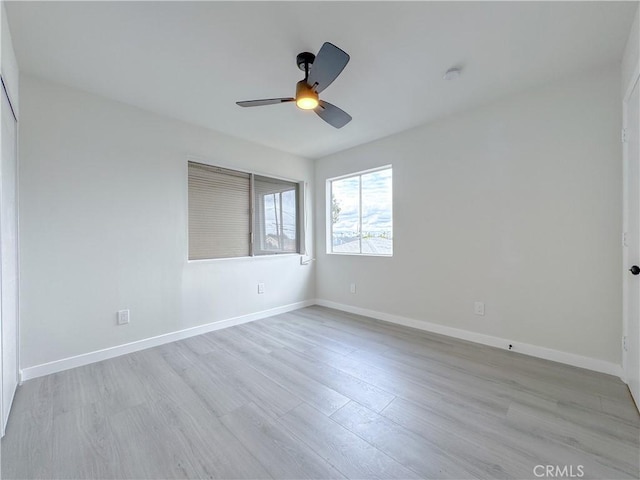 unfurnished room with ceiling fan and light hardwood / wood-style flooring