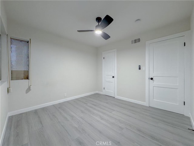 unfurnished bedroom with ceiling fan and light wood-type flooring