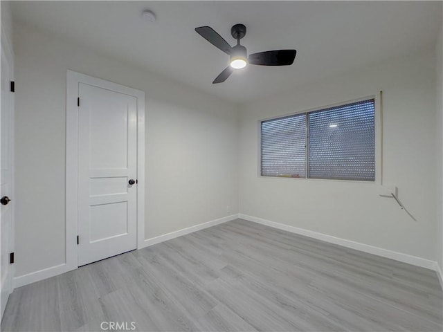 empty room with light hardwood / wood-style floors and ceiling fan