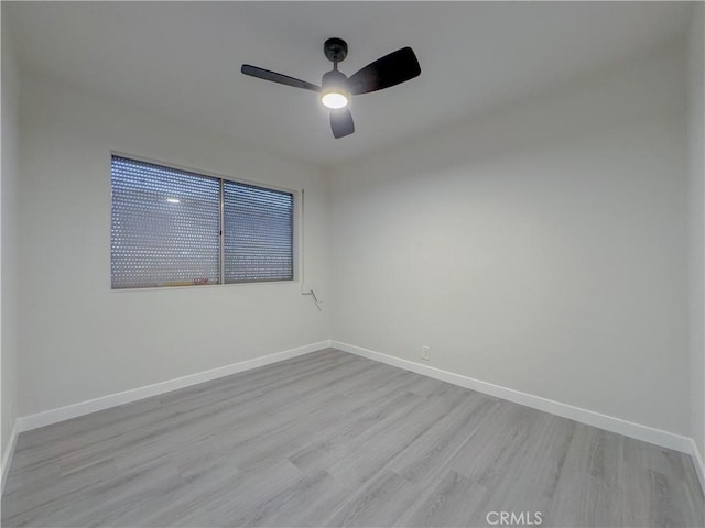 spare room featuring ceiling fan and light hardwood / wood-style flooring