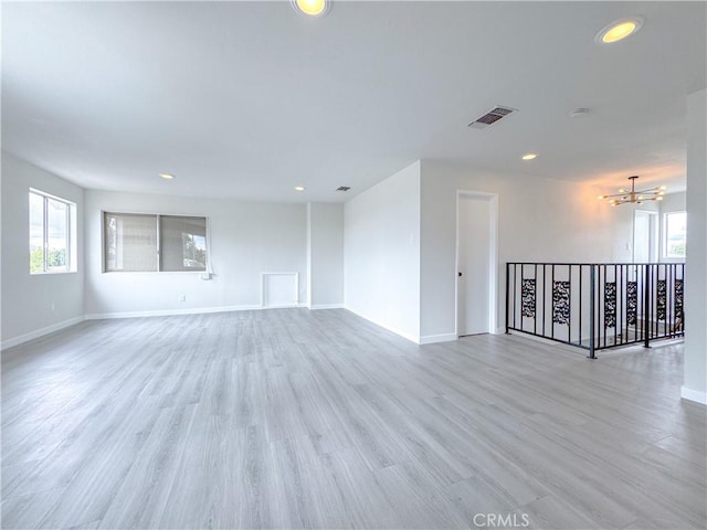 unfurnished room with light wood-type flooring