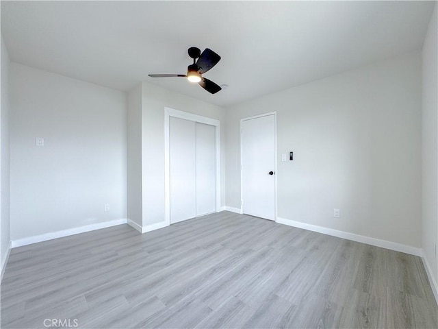 unfurnished bedroom featuring a closet, ceiling fan, and light hardwood / wood-style flooring